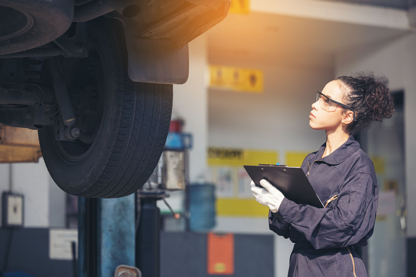 Mechanic examining underside at car service, Auto Repair Service.